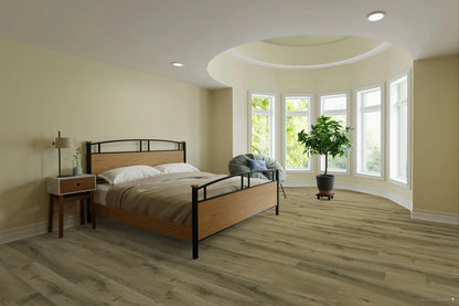 A modern bedroom featuring light gray wood-look plank flooring, beige walls, a wooden and black metal bed frame, a matching nightstand, and a large potted plant near a curved bay window.