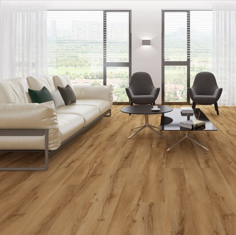 Light oak wood plank flooring shown in a modern, bright living room setting with a cream sofa, two gray armchairs, and a glass coffee table.