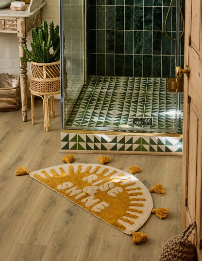 Ambleside Oak Luxury Click Vinyl Flooring 5mm in a stylish shower room with warm oak-effect planks, green patterned tiles, brass details and rustic bathroom décor.