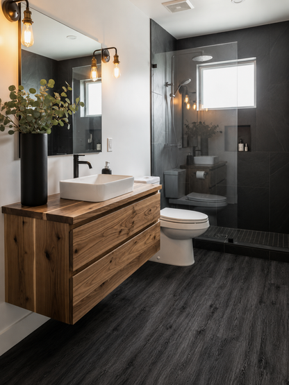 Black Ash SPC flooring in a modern bathroom with realistic dark oak wood grain planks, waterproof luxury vinyl flooring, floating timber vanity, frameless shower enclosure, black feature tiles and contemporary bathroom décor.