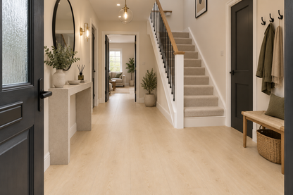 A bright, modern entryway with light oak wood flooring, a staircase with beige carpet and black balusters, a concrete console table, and a wooden bench with a basket on the right.