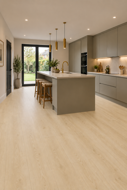 Light oak wood flooring in a modern kitchen setting, showing a clean interior with grey cabinets, a central island, and pendant lights.