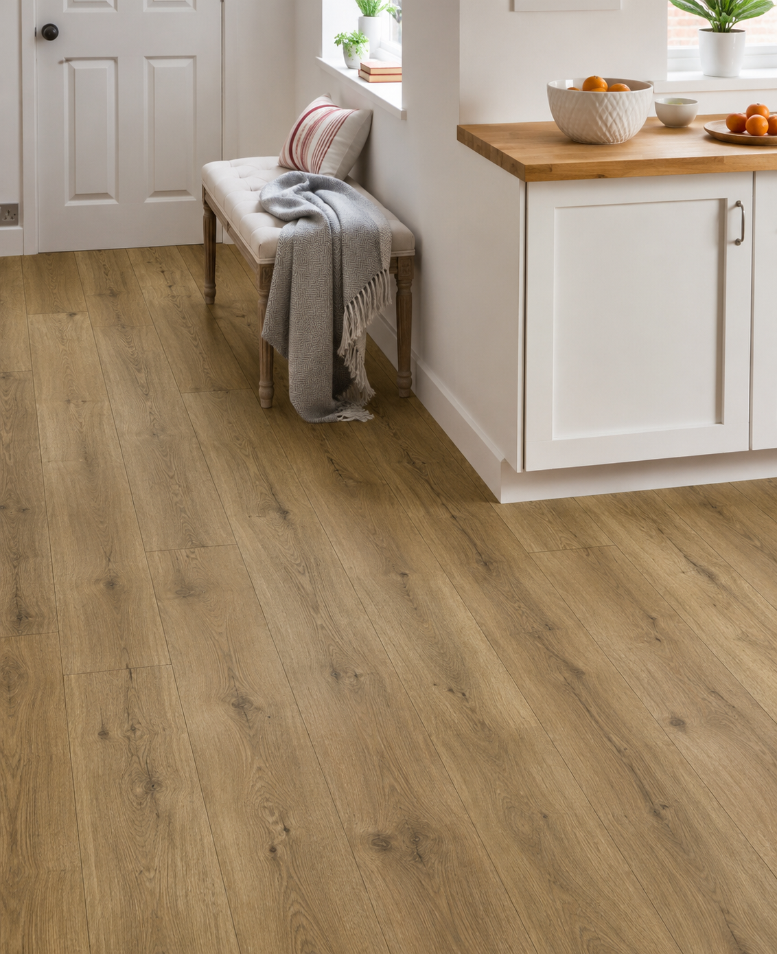 Fellside Oak XL Luxury Click Vinyl Flooring 7mm in a bright modern kitchen, showcasing extra-large natural oak-effect planks with realistic wood grain, authentic knots, textured matt finish and waterproof SPC click flooring.
