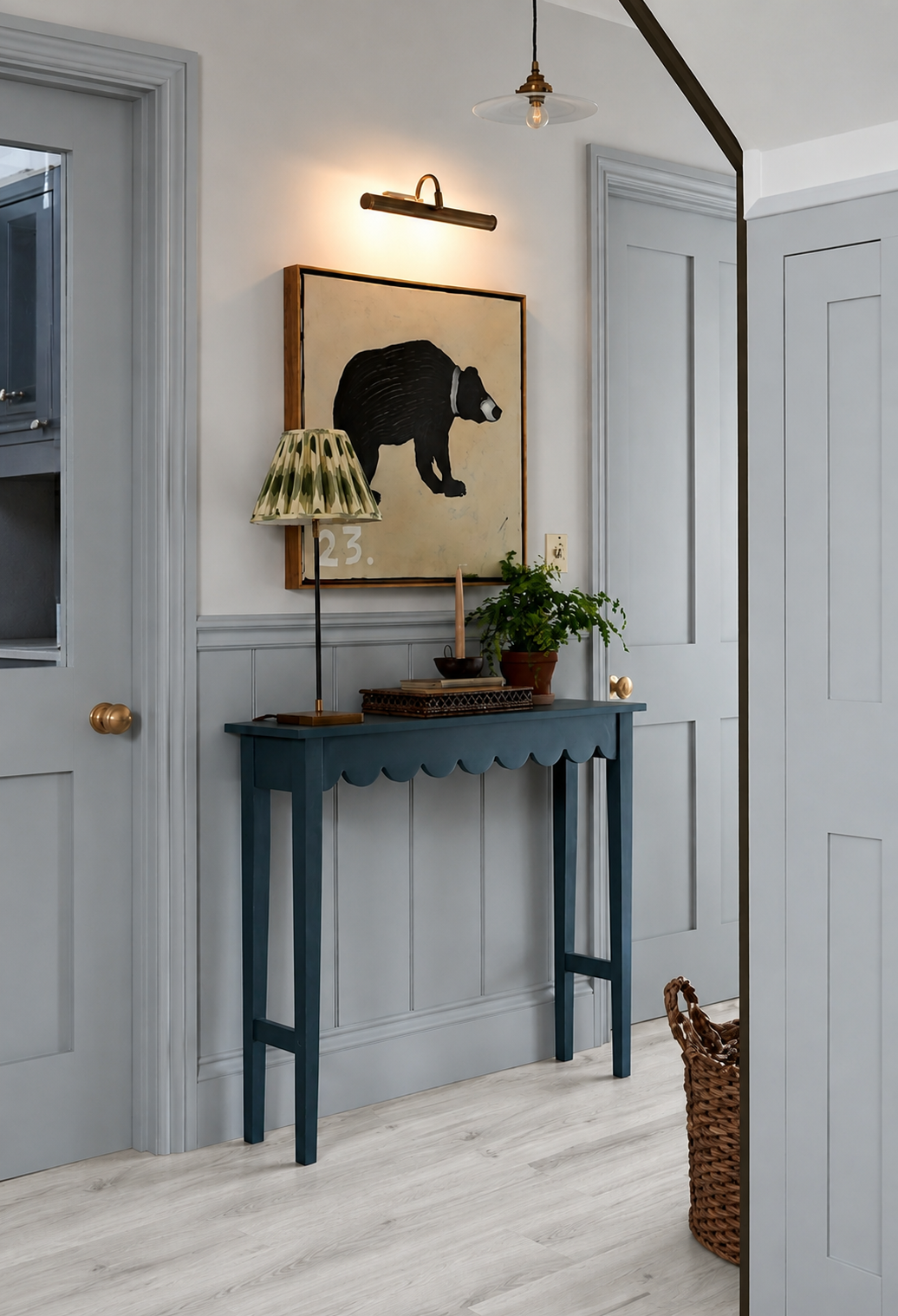 Kirkstone Grey Oak Luxury Click Vinyl Flooring 5mm in a stylish hallway with soft blue-grey panelling, painted doors and a dark blue console table.