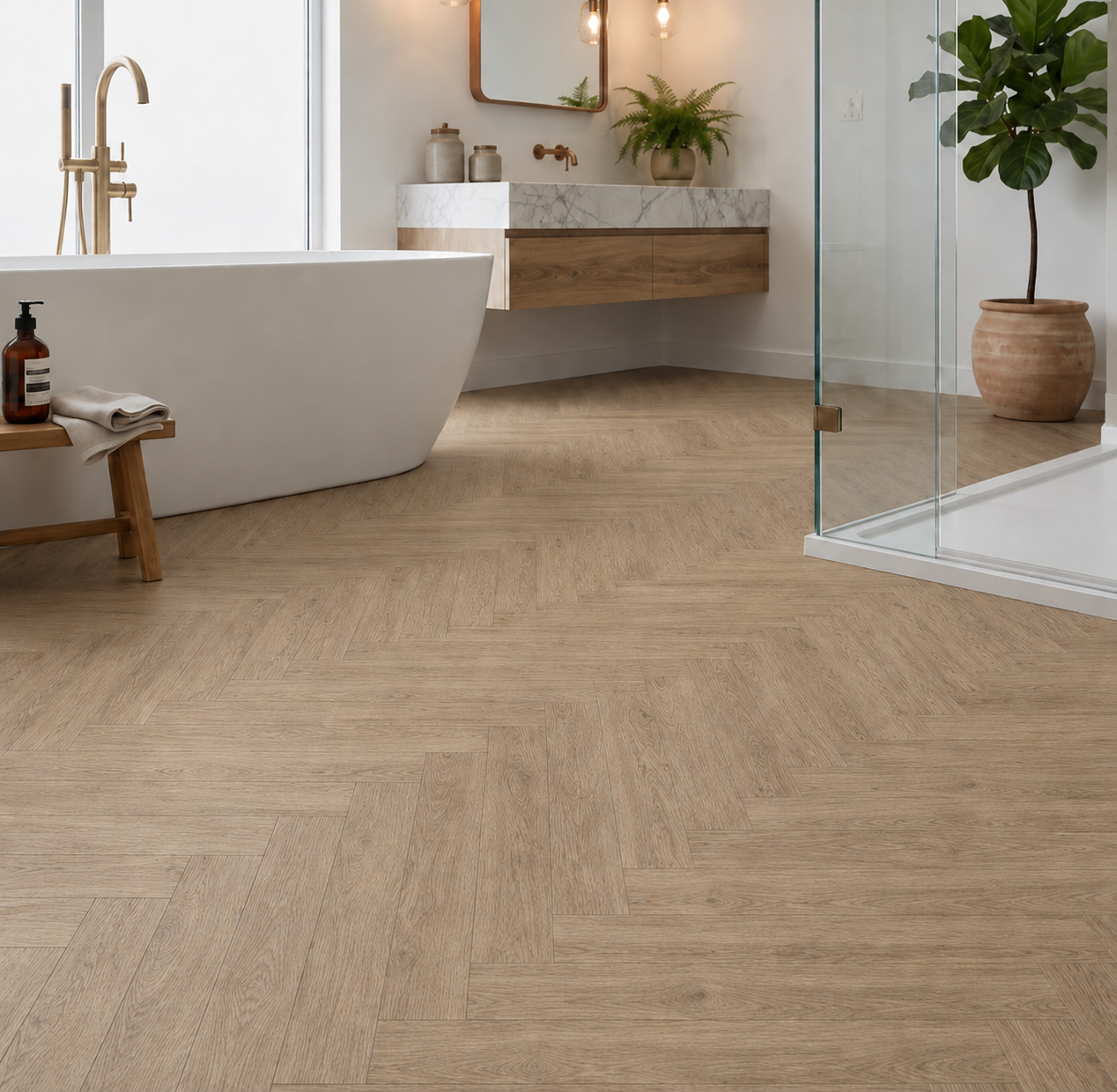Amazon Oak Herringbone Luxury Click Vinyl Flooring in a modern bathroom, showcasing light oak-effect herringbone vinyl flooring with realistic wood grain detail and natural beige tones. Waterproof click vinyl flooring installed beneath a freestanding bathtub and walk-in shower, highlighting durable wood-look flooring for bathrooms, en-suites and contemporary homes.