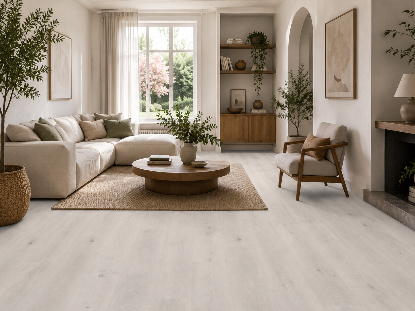 Pewter Grey wood effect plank flooring in a bright contemporary living room with Scandinavian-inspired styling, featuring pale grey oak grain luxury vinyl flooring, neutral sofa, wooden coffee table, indoor plants and large windows. Waterproof, durable LVT/SPC flooring ideal for living rooms, open-plan spaces and modern family homes.