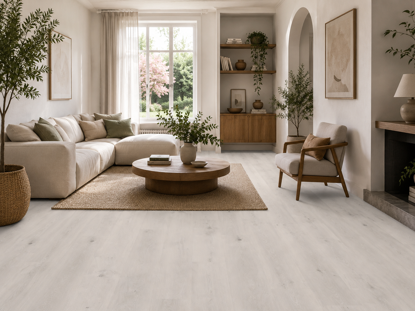 Pewter Grey wood effect plank flooring in a bright contemporary living room with Scandinavian-inspired styling, featuring pale grey oak grain luxury vinyl flooring, neutral sofa, wooden coffee table, indoor plants and large windows. Waterproof, durable LVT/SPC flooring ideal for living rooms, open-plan spaces and modern family homes.