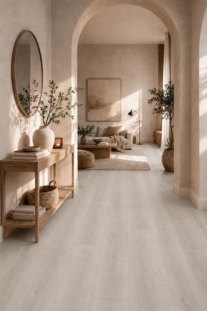 Pewter Grey Oak SPC flooring in a stylish hallway with authentic light grey oak wood grain planks, waterproof luxury vinyl flooring, neutral décor, arched entranceway, wooden console table and modern open-plan living space.